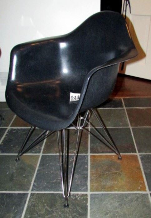 One of 4 black plastic, wire base EAMES chairs