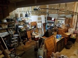 Packed garage has furniture, tools, outdoor items, rugs, lighting, window treatments, tools, garden supplies, and more