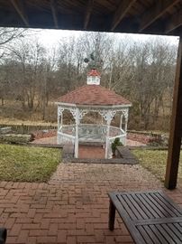 Vintage wood glider in gazebo is not for sale, but it is a pretty view out back, if you want to buy this home !