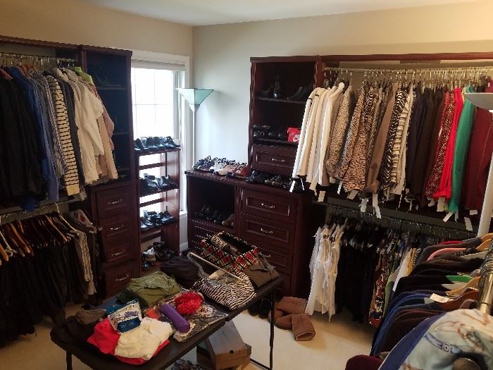 Boutique style walk-in closet filled with goodies