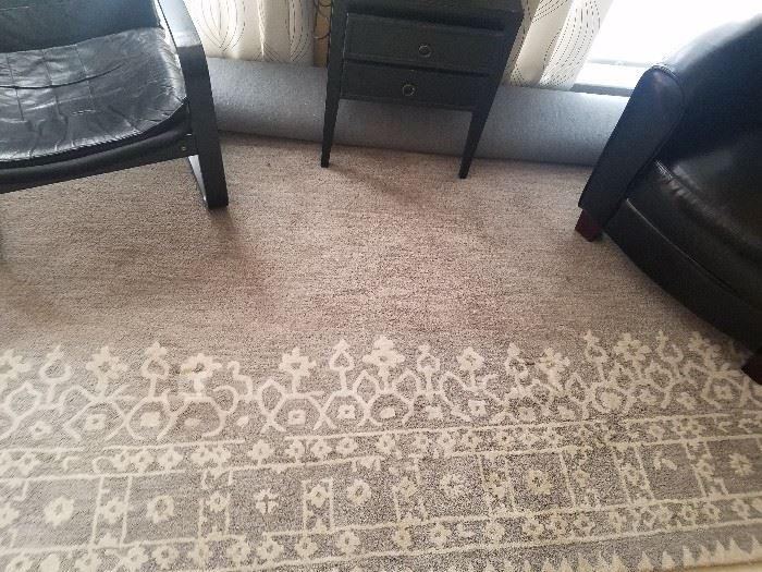Beautiful neutral area rug- shown rolled up with patterned border showing