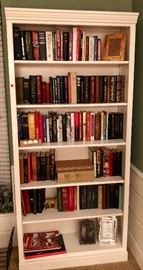 bookshelf with books, etc.