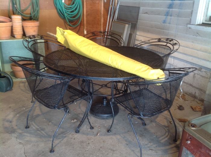 Outdoor wrought iron set...table with five chairs....umbrella and stand.  $150