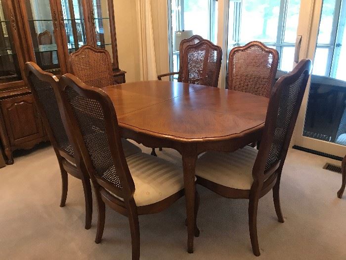 Thomasville - French Provincial - Pecan finish - 2 table leaves with custom pads.  2-End Chairs 6-Side Chairs made of wood with Pecan finish, with cane backing to chair and fabric seat cushions