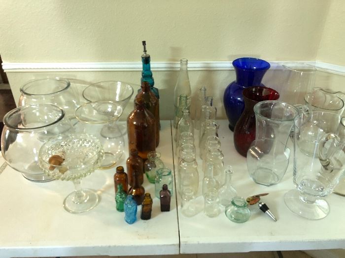 Glassware galore!  Tons of old bottles, vases, pitchers, stemware, china, unique footed bowls