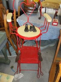 Antique wrought iron shoe shine stand.