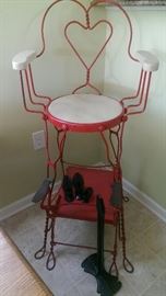 Full view of wrought iron shoe shining stand