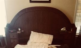 King size headboard... queen size mattress set up in front of it.  The headboard has lots of little drawers and shelves for great usability!    