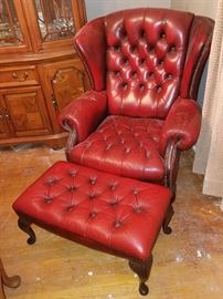 Red leather tufted chair with ottoman