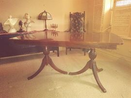 Mahogany dual pedestal table with leave inset under the top.