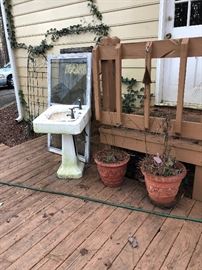 antique pedestal sink, screen, window, flower pots, trellis