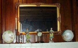 Assorted items: large porcelain man and woman figurines, porcelain serving bowls, Brass candlestick holders, gold mantle clock w/key