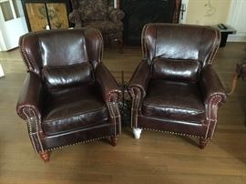 PAIR OF NEW LEATHER ARMCHAIRS--WHITE LEG IS THE ORIGINAL PROTECTIVE PACKING MATERIAL THAT HAS NOT BEEN REMOVED.