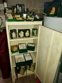 Snow babies in vintage metal cabinet