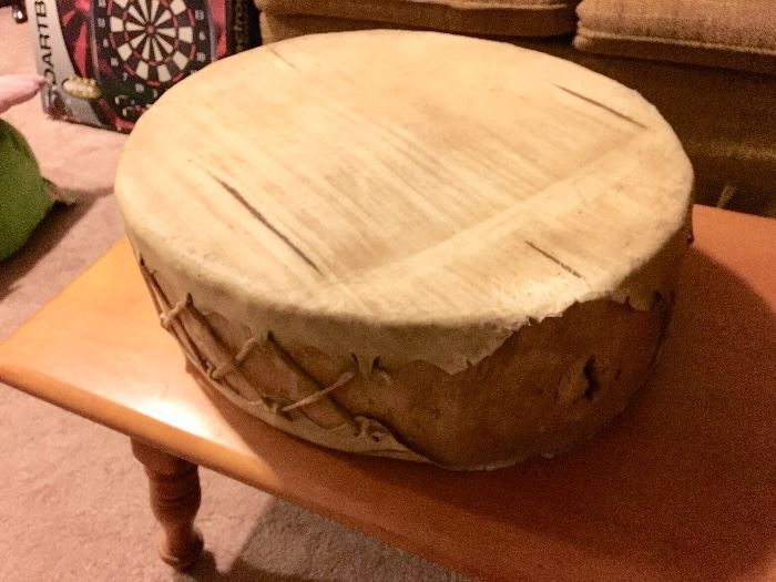 Stretched animal skin drum carved from tree slice