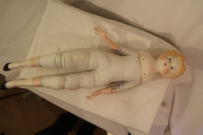 Doll with painted face and shoes, leather body