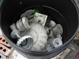 GARBAGE CANS FILLED WITH ALL SORTS OF VASES AND POTS