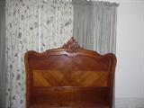 CLOSEUP OF HAND CARVING ON HEADBOARD