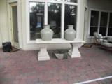 STONE TABLE WITH TWO LARGE POTTERY JUGS
