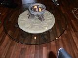 GLASS TOP COFFEE TABLE MADE FROM STONE CART WHEEL