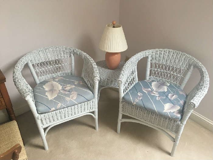 Two matching wicker chairs, table and lamp.