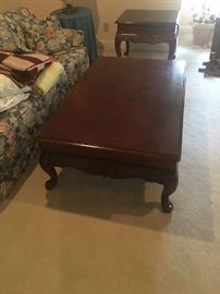 Large wooden carved coffee table with two side tables to match.  Patterned sleeper sofa in the background-also for sale.
