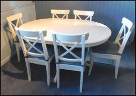  White Ikea table with six chairs and one leaf. 43" diameter without the 17" leaf