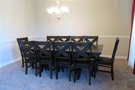 Table has a self storing leaf.  10 chairs.  Like NEW condition. 