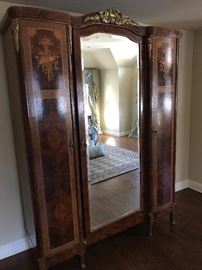 Antique turn of the century mirrored armoire with inlay detail. 