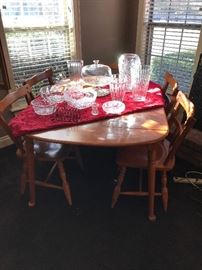 1960's solid wood dining room table.  Includes 2 leaves. 
Wonderful crystal vases, some are by Mikasa.