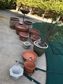 Lots of terra cotta pots in various sizes. 