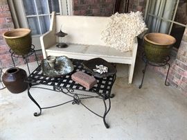 Heavy vintage pew/bench and nice iron table. Iron plant stands and matching pots. 