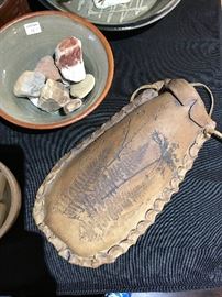 Very unique wall pocket made of pottery and leather.