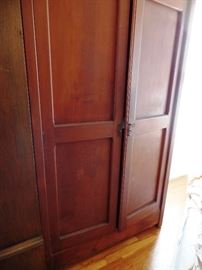 One of several armoires in different woods