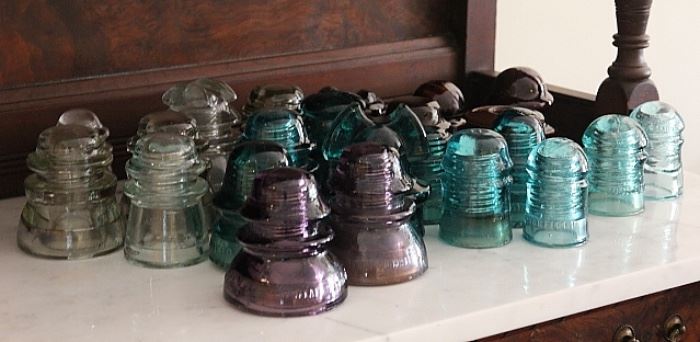 collection of antique glass insulators in various colors