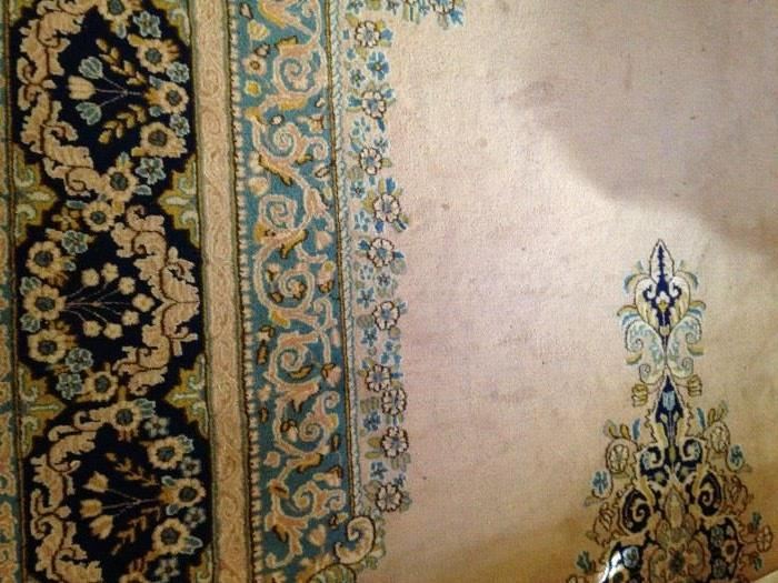 Large rug in tan, gold, and blue