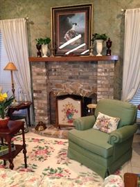 Framed art, fire screen, large rug, and occasional chair