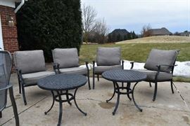 Outside Lawn furniture with cushions and 2 small tables.
