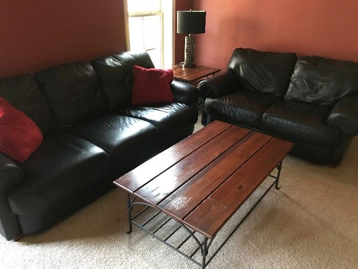 Leather couch and love seat set. Wood and metal coffee and end tables.