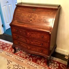 Serpentine front drop front inlaid desk with brass gallery rail. 