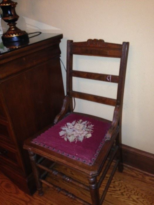 One of two matching needlepoint seat antique chairs