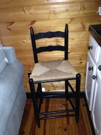 One of two matching black bar stools