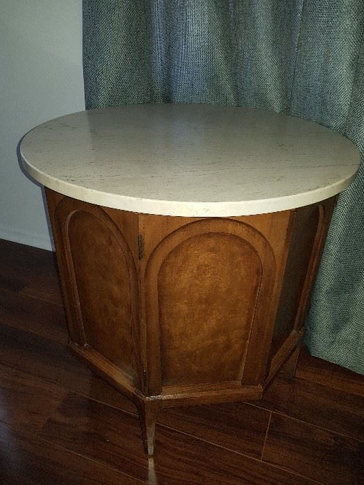 This nightstand has a marble top, and is part of the vintage Thomasville bedroom set!