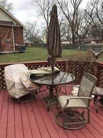 Patio table, umbrella and 2 chairs (at least so far - perhaps more will be uncovered!)