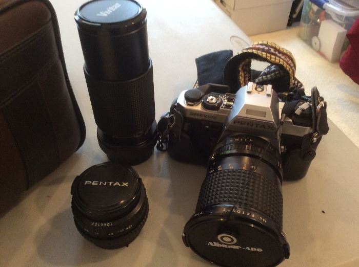 Pentax camera, several lenses and camera bag