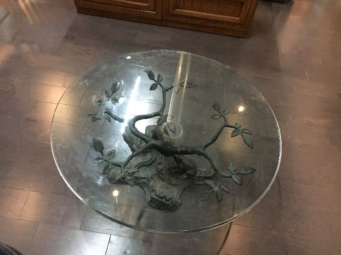 Glass top coffee table with metal branch and frog base