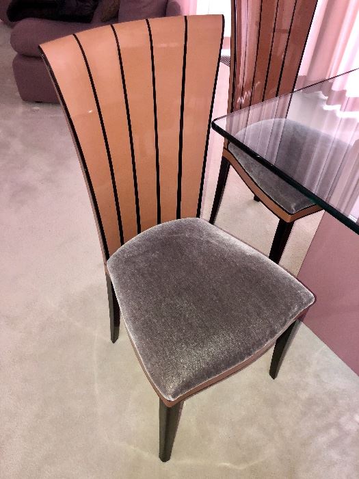 Saarinen House side chairs are padded and covered with Mohair upholstery. Solid Maple wood in a beautiful honey color and ebony lacquer trim.  The backs of the chairs have a fluted shape that is emphasized by the vertical ebony trim.