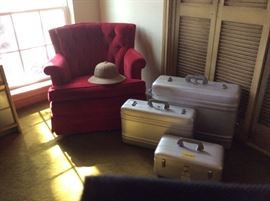 Halliburton luggage, red velvet arm chair. 