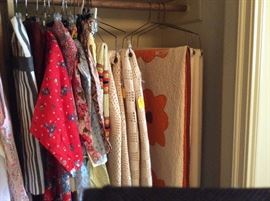 Vintage aprons and wool blankets and a quilt 