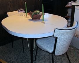 Formica Table with 2 Extensions( one photographed) and 6 Matching Chairs(2 shown)
